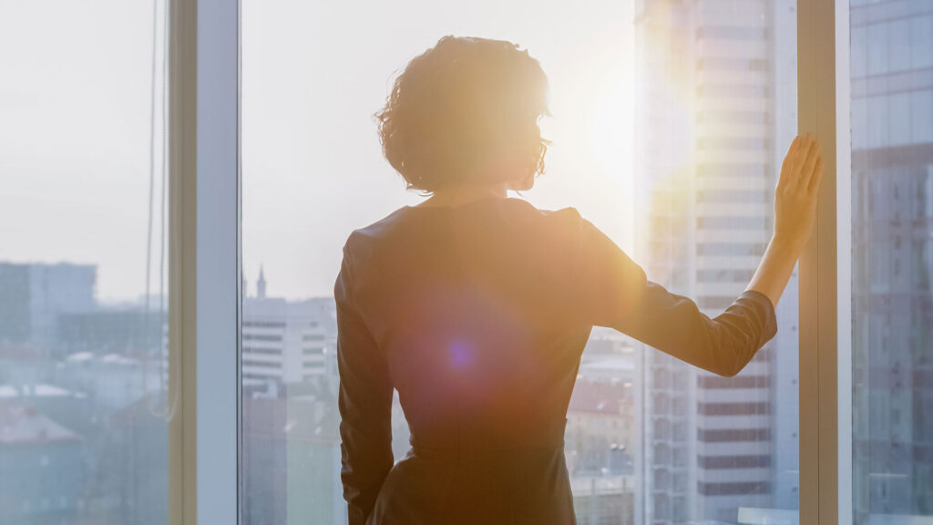 Front page photo from Darize's annual report: woman looking at horizon