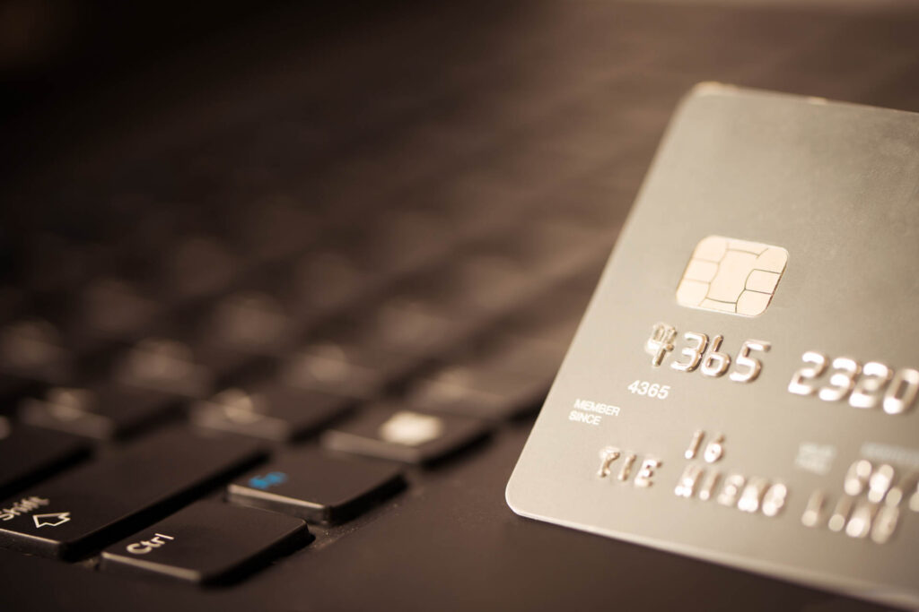 Credit card on laptop for online payment or shopping concept