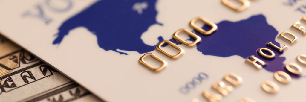 Credit card and banknotes representing digital and cash payments