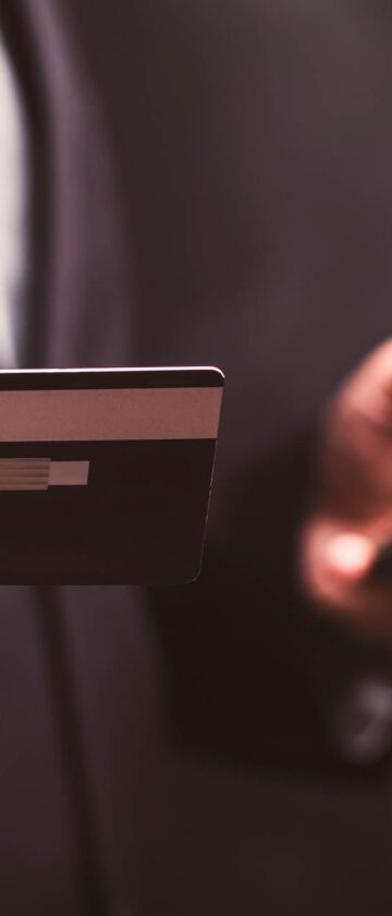 Person using a credit card and smartphone for digital banking