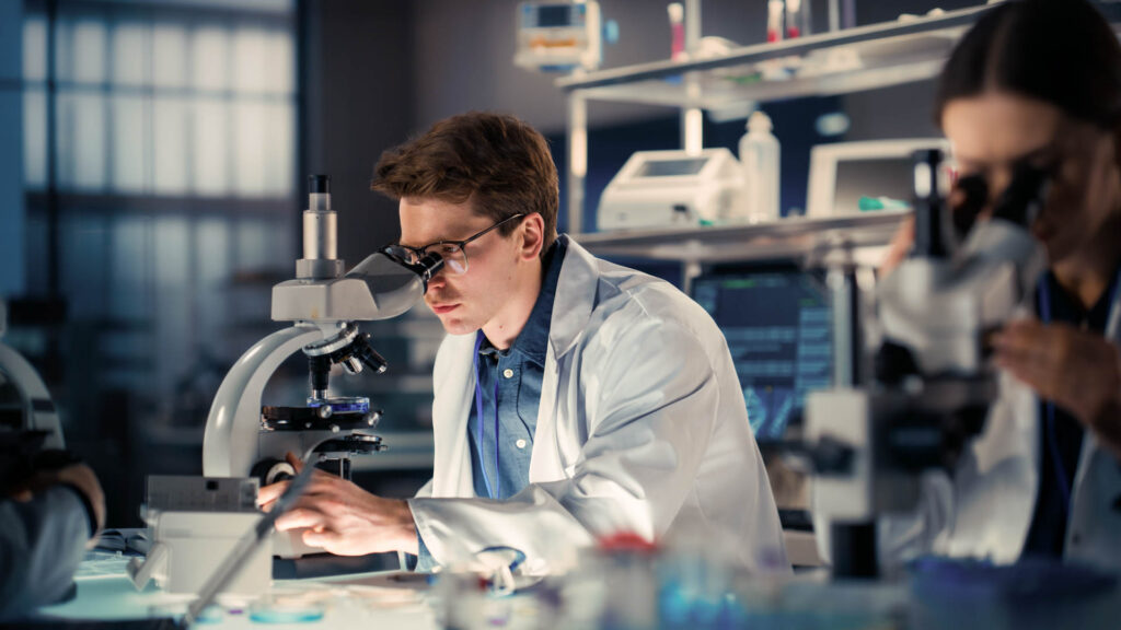 Medical research scientists working with a microscope in a laboratory