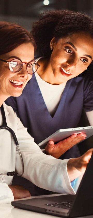 Doctor and nurse reviewing information on a laptop in a hospital